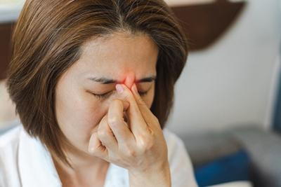 Woman with sinusitis in red