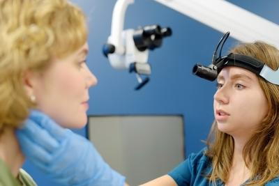 ENT doctor checking patient’s neck and throat for symptoms