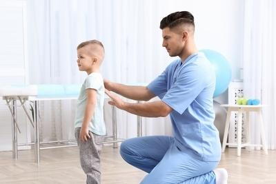 Young boy with the chiropractor checking his back