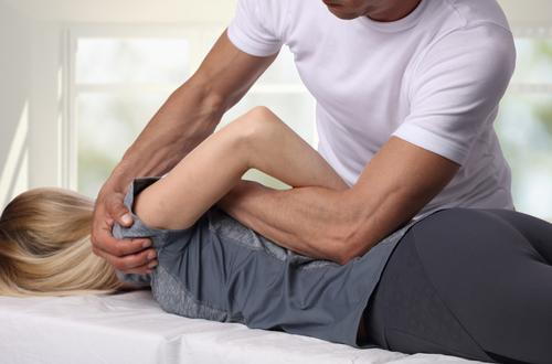 Osteopathic physician performing hands-on treatment to improve body structure and mobility