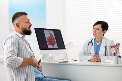 Male patient consulting a gastroenterologist about digestive issues.