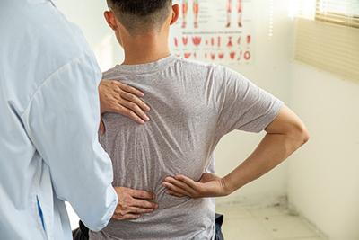 Man-with-Back-Pain-Visits-Chiropractor-for-Treatment