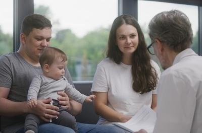 Doctor talking to a family with a child