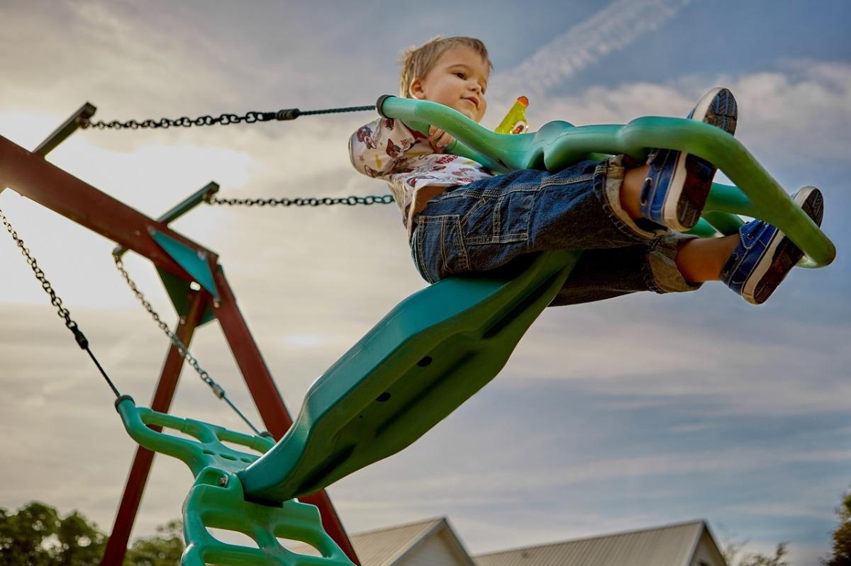 A young child using playground equipment