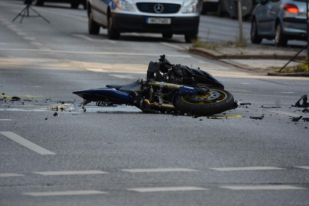 A wrecked motorcycle in the street