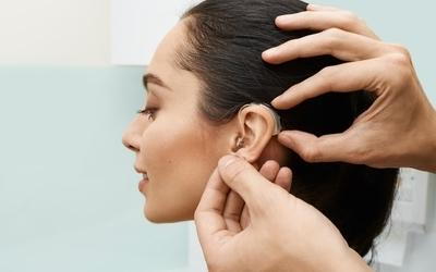 Woman with hearing aids in her ear