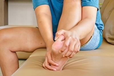 Person suffering from Plantar Fasciitis on bed