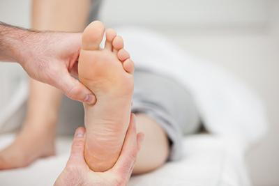 Doctor massage of a person having a foot pain