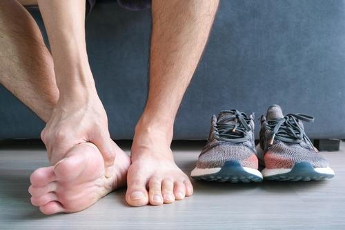 Man experiencing heel pain from plantar fasciitis