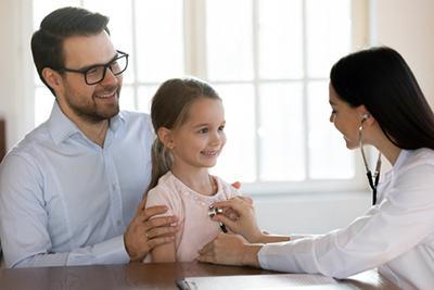 Smiling-Kid-Suring-Her-Checkup-With-Female-Pediatrician