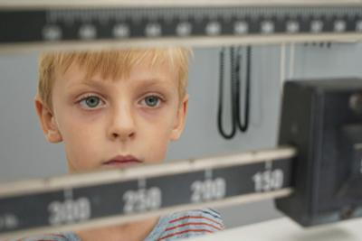 Kid-is-Being-Weighed-For-a-Routine-Check-Up