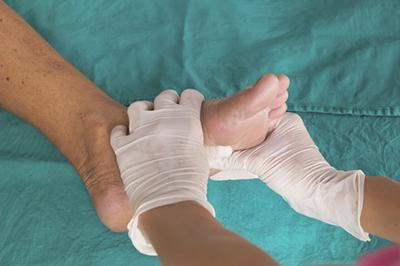 Doctor checking the condition of foot on patient