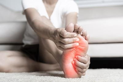 Person suffering in Plantar Fasciitis in red highlight.