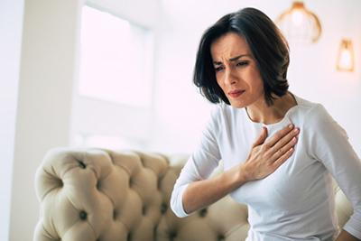 Woman in chest pain holding her chest