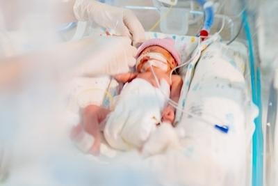 Doctor taking care of child in incubator