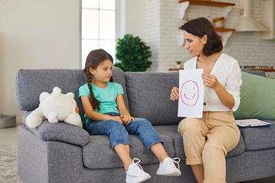 Child receiving behavioral evaluation from pediatric specialist