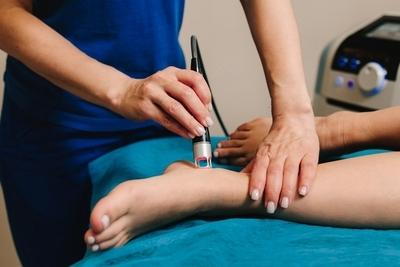 Doctor-performing-MLS-Laser-Therapy-in-Foot