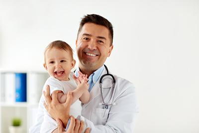 Doctor  is happy with the little boy on clinic.