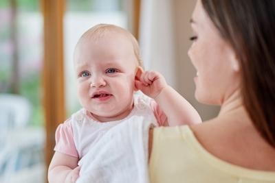 Little baby scratching ears with the mother beside it.