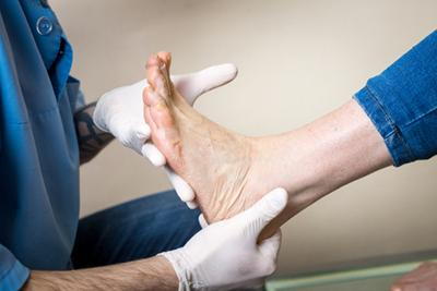 Foot-Doctor-Checking-Client's-Feet