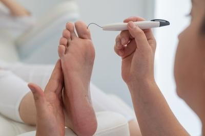 Doctor-test-foot-for-patient-with-diabetes-in-clinical-bed.