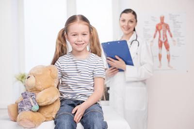 Smiling-Young-Girl-with-the-Doctor-in-Clinic
