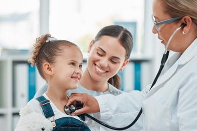Little girl looking happy check by doctor with the mother on clinic.