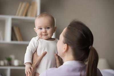 Mother taking care of her son in home.