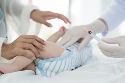 Doctor preparing a vaccination for baby