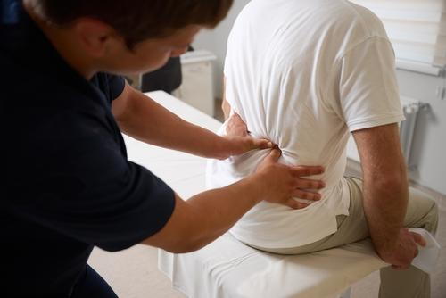 Chiropractor providing back pain treatment