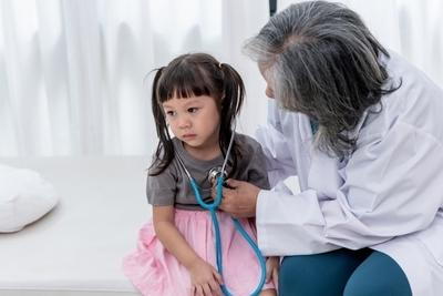 Young child having checkup on the doctor.
