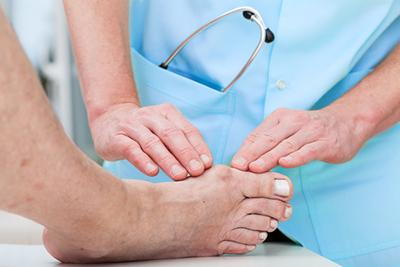 Foot-Specialist-Examining-Bunion-on-Patient's-Foot