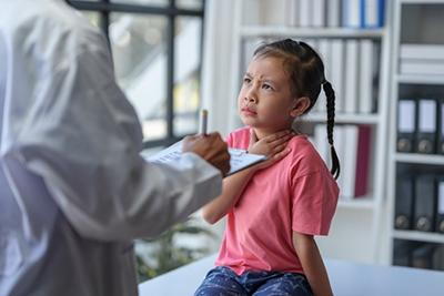 Child visiting doctor for strep throat symptoms