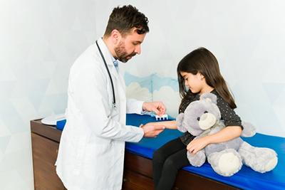 Pediatrician conducting allergy skin test on a child
