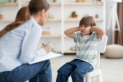 Child being evaluated by a pediatrician for behavioral concerns