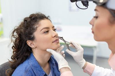Young woman in nose evaluation by the doctor