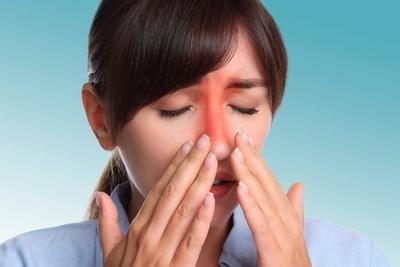 Woman suffering from Sinus Infection with redness