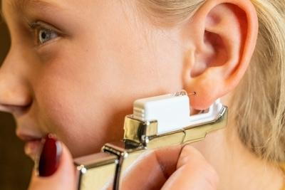 Young girl in Ear Piercing Procedure