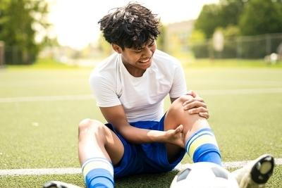 Soccer Player suffering from injuries on the field