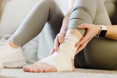 Lady runner suffering from ankle injury