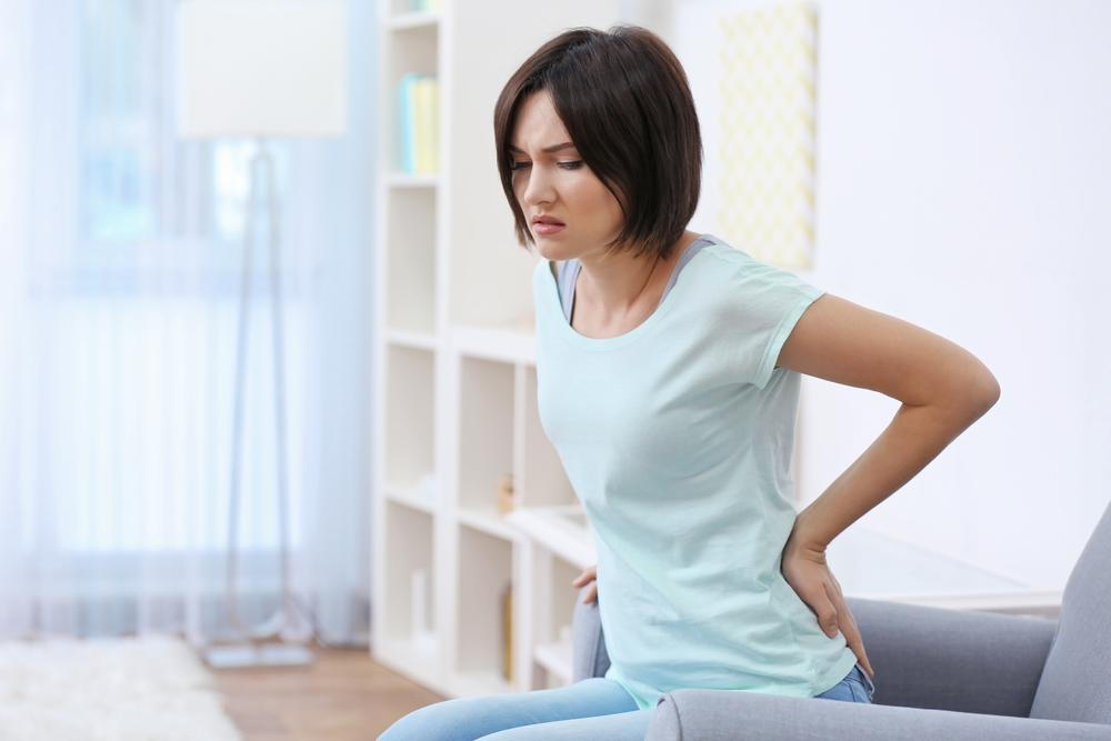 woman suffering from pain due to sitting for a long period of time