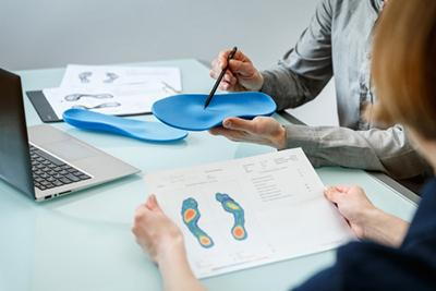 Podiatrist-Discussing-Custom-Orthotics-with-Patient