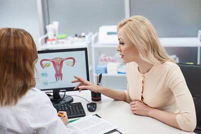 Doctor-and-Patient-Looking-in-the-Model-of-Ovary-in-Monitor