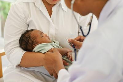 Doctor-checks-newborn's-health-during-visit.