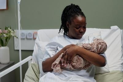 Mother taking care of her baby on clinical bed