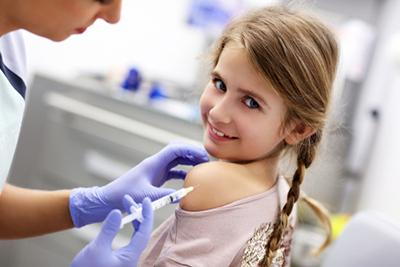 Doctor giving a vaccine for a little girl.