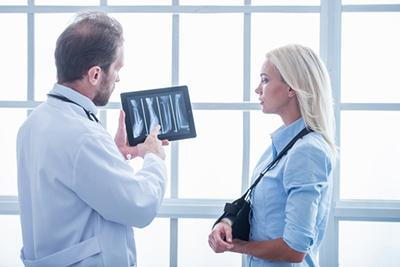 Doctor-Discussing-Bone-Health-X-ray-with-Menopausal-Woman