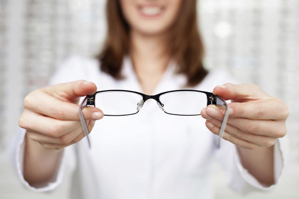 Optometrist holding glasses