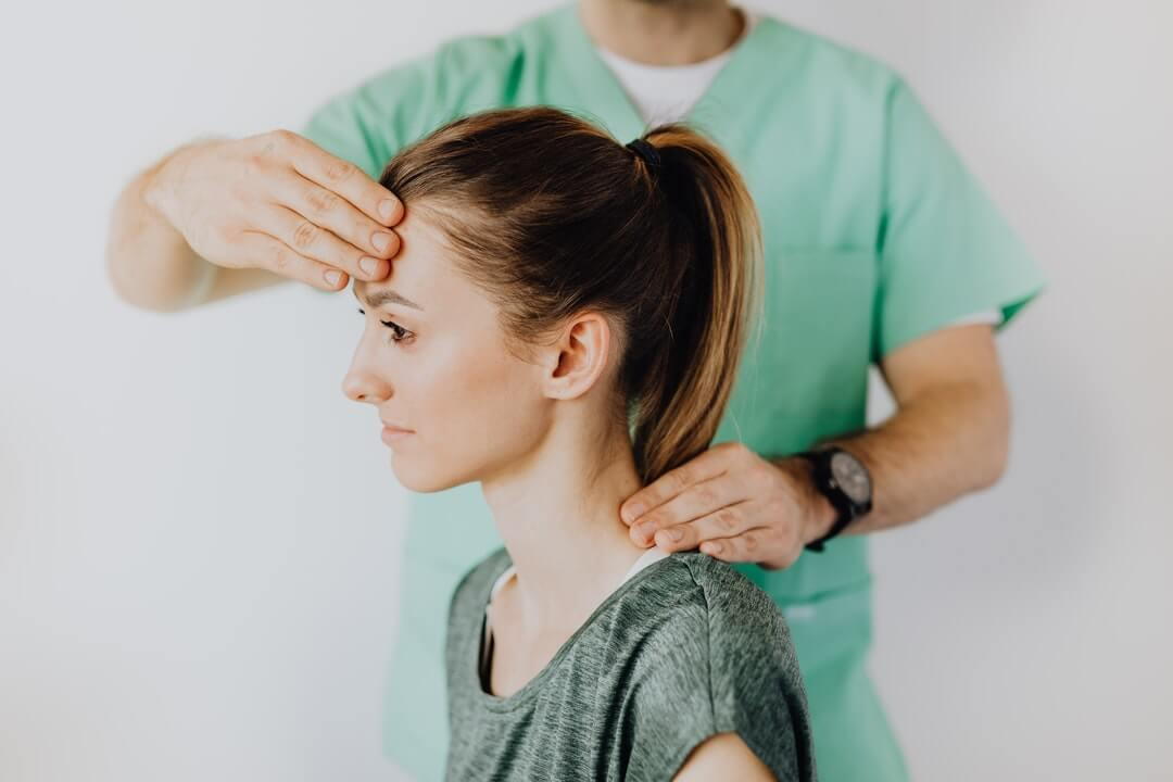 Chiropractor is treating a patient with migraine