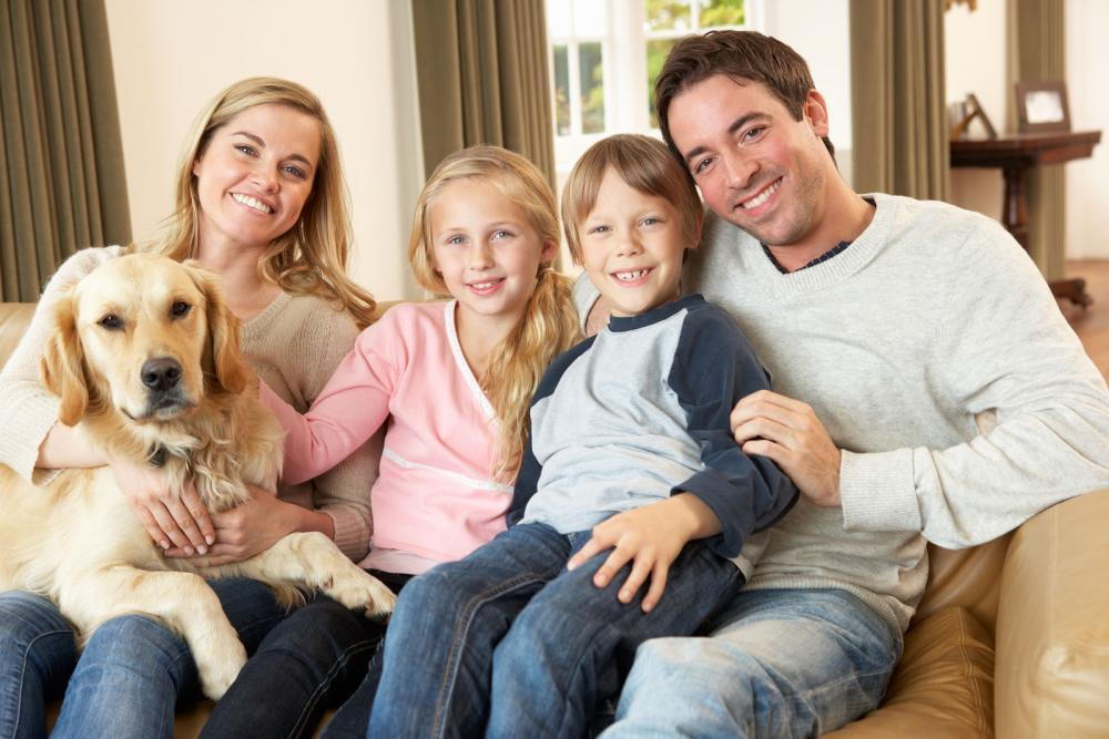 Family happy with their newly healthy dog.